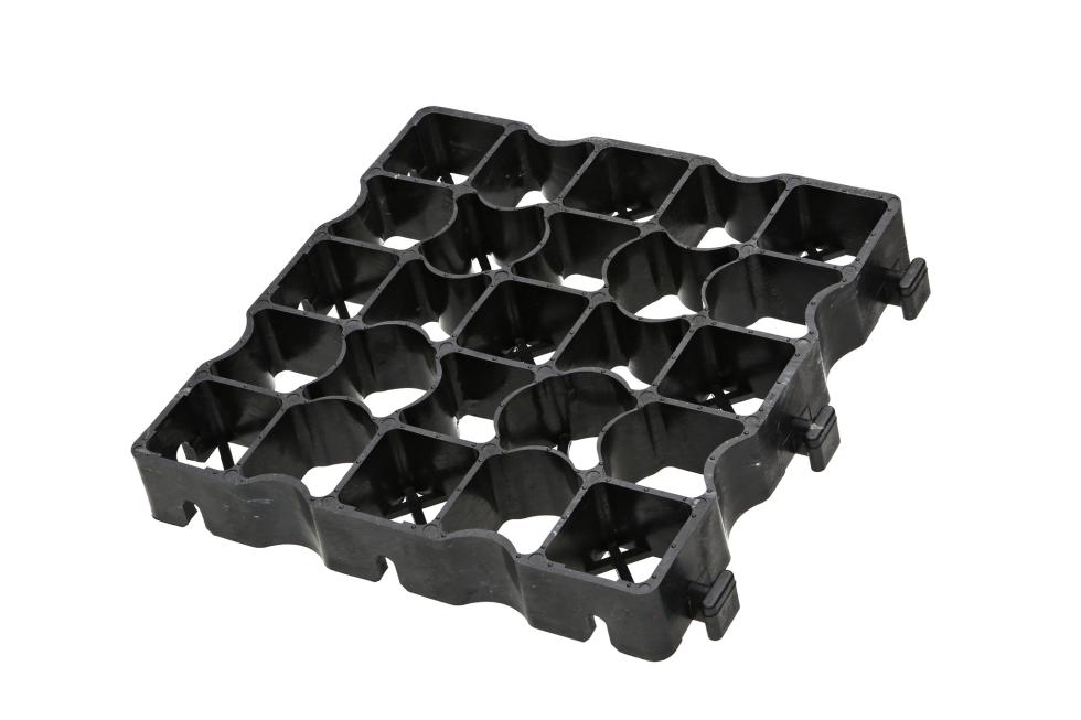 Ein Ecken eines grauen Kunststoffecorasters, untereinander verbindbar an Zäpfchen